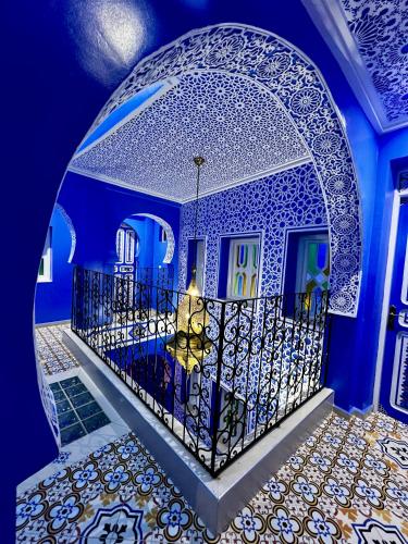 a blue room with a gate and a tile floor at RIAD CHENGLI 蓝城里 in Chefchaouene