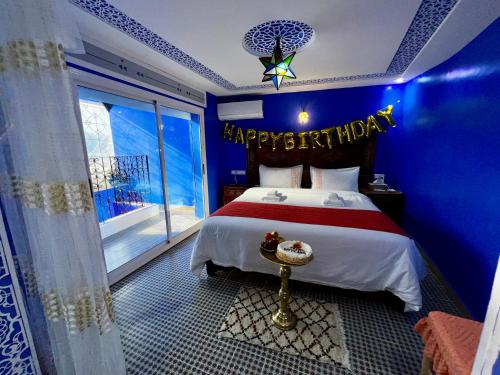 a bedroom with a happy birthday sign on a bed at RIAD CHENGLI 蓝城里 in Chefchaouene