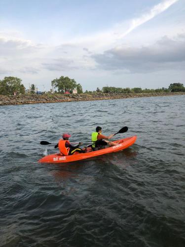two people in a kayak on a body of water at Hotel Sanhida Polonnaruwa in Polonnaruwa