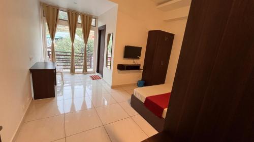 a bedroom with a bed and a television in it at Hotel Rewalsar Heights in Mandi