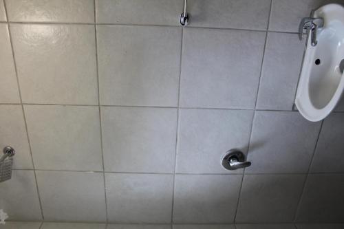a tiled shower with a urinal in a bathroom at Self-catering rooms Florida in Roodepoort