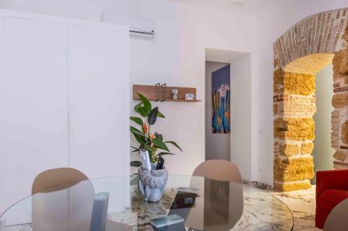 a living room with a red couch and a vase at Hotel Exclusive in Agrigento