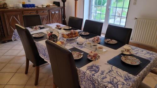 a dining room table with plates of food on it at Maison St. James in Saint-James