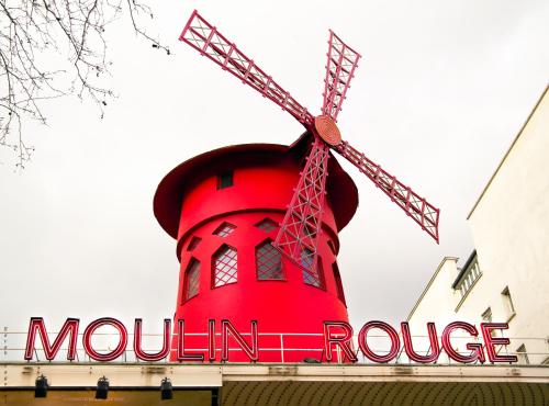 a large red windmill on top of a building at Hotel Audran in Paris