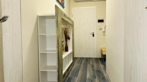 a hallway with a mirror next to a door at Maison Elsa in San Vito Chietino