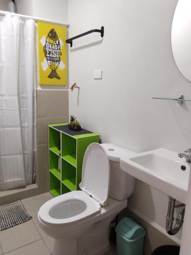 a bathroom with a toilet and a sink at E214 Place at SMDC Cheer Residences in Marilao