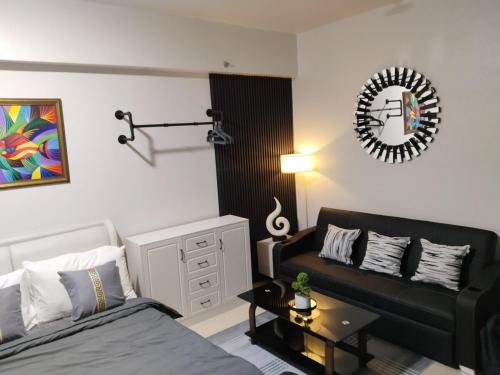 a living room with a bed and a couch at E214 Place at SMDC Cheer Residences in Marilao