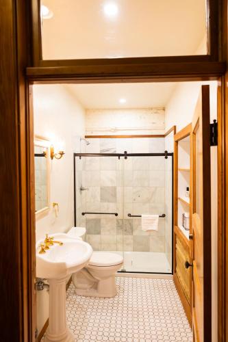 a bathroom with a shower and a toilet and a sink at Lander Millhouse in Lander