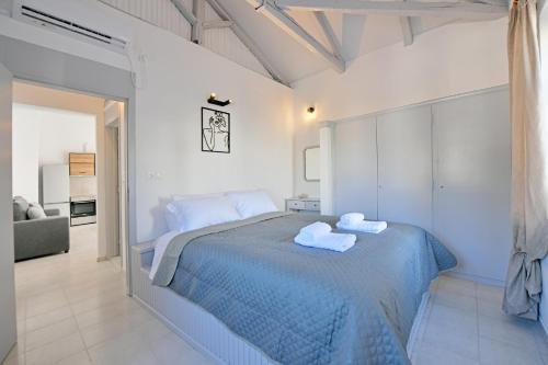a bedroom with a bed with two towels on it at Aori Guest House I in Hydra