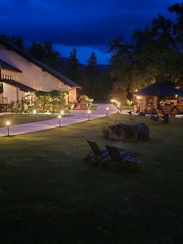 a couple of chairs in a yard at night at Penzion Pibernik in Bled