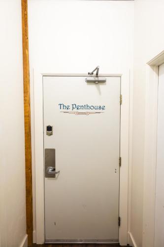 a white door with a sign that reads the penthouse at Lander Millhouse in Lander