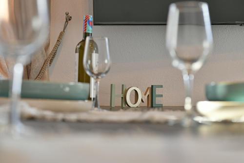 a table with wine glasses and a bottle of wine at Aori Guest House I in Hydra