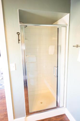 a shower with a glass door in a bathroom at Lander Millhouse in Lander