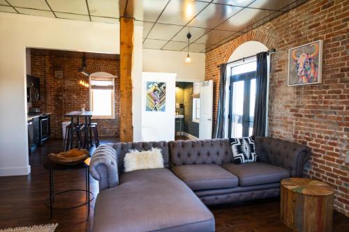 a living room with a couch and a brick wall at Lander Millhouse in Lander