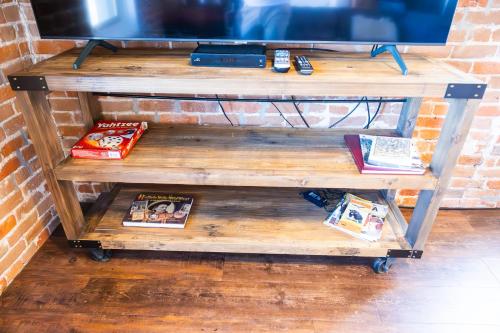 a wooden tv stand with books on it at Lander Millhouse in Lander