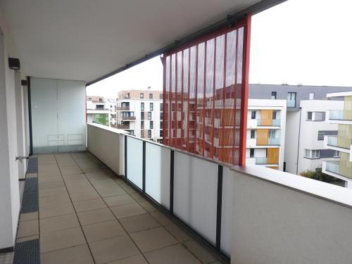 an empty balcony with a view of a building at Wien Schwechat Apartment Airport in Schwechat
