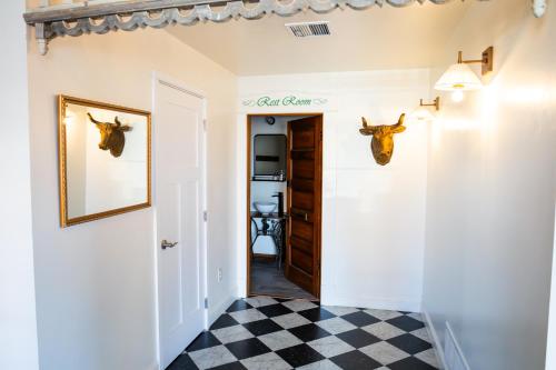 a hallway with a door with deer heads on the wall at Lander Millhouse in Lander