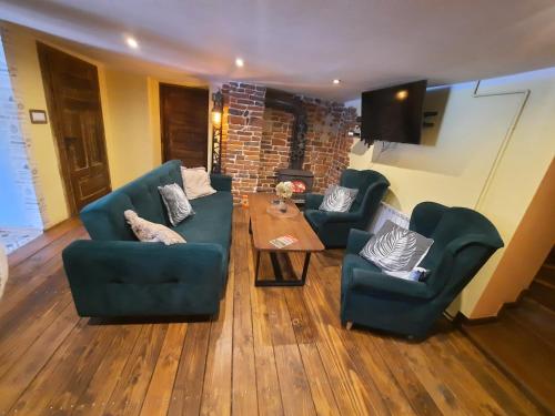 a living room with two blue couches and a table at Gościna U kowala in Lachowice