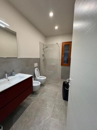 a bathroom with a sink and a toilet and a shower at Casa Lucia in Strada