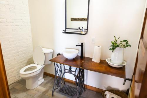 a bathroom with a toilet and a sink at Lander Millhouse in Lander