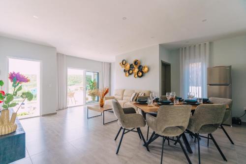 a dining room with a table and chairs at Casa Sun's Buddy in Willemstad