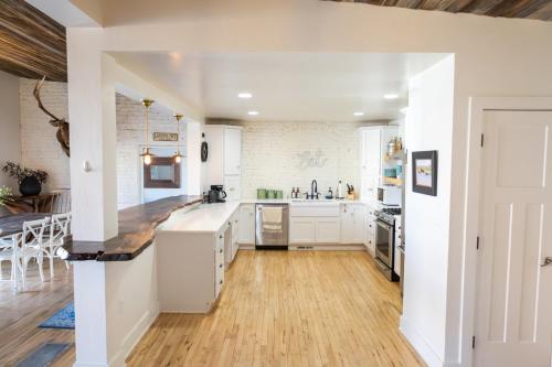 a kitchen with white cabinets and a wooden floor at Lander Millhouse in Lander