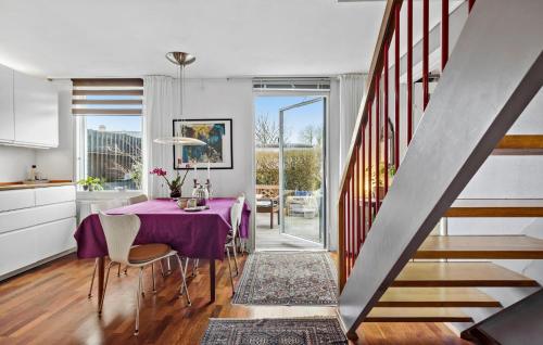 a dining room with a purple table and chairs at 2 Bedroom Gorgeous Home In Espergærde in Espergærde