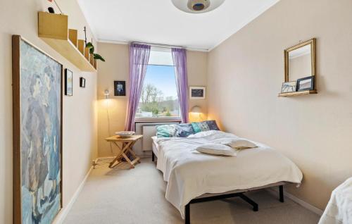 a bedroom with two beds and a window at 2 Bedroom Gorgeous Home In Espergærde in Espergærde
