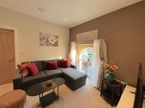a living room with a couch and a table at Glastonbury Gem, 2 Bedroom Apartment in Glastonbury