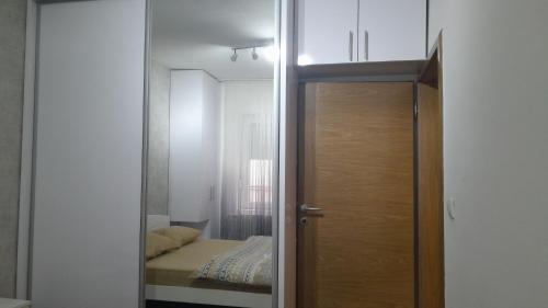 a door leading into a room with a bedroom at Apartman Roma in Brčko