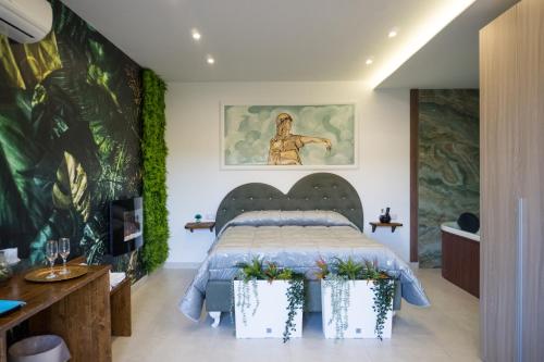 a bedroom with a bed and a painting on the wall at Etna Exclusive in Ragalna
