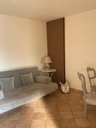 a living room with a couch and a table and chairs at Rhome country lodge in La Massimina-Casal Lumbroso