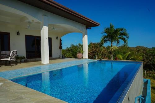 a swimming pool in front of a house at Casa Nero Panama in Boca Chica