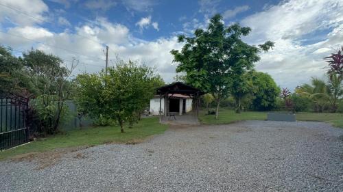 a small house with a black roof in a yard at Casa Nero Panama in Boca Chica