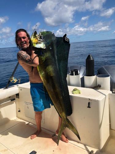 a man holding a large fish on a boat at Casa Nero Panama in Boca Chica