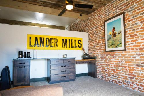 a brick wall with a desk and a sign on it at Lander Millhouse in Lander