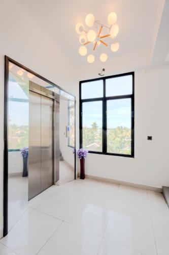 an elevator lobby with a glass door and a window at Mzion Hotel Weligama in Weligama