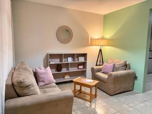 a living room with two couches and a table at Casa Boho in Quesada