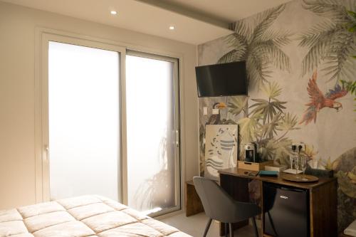 a bedroom with a bed and a desk and a window at Etna Exclusive in Ragalna