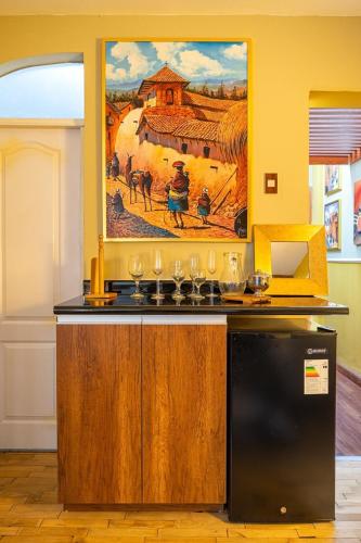 a kitchen with a painting on the wall at Classy Andino & primer piso, 2 dormitorios in Lima