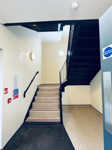a staircase in an office building with blue stairs at Pears Suite - 1 Bedroom - Sleeps 2 in Whitehaven