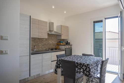 a kitchen with a table and a dining room at Etna Exclusive in Ragalna
