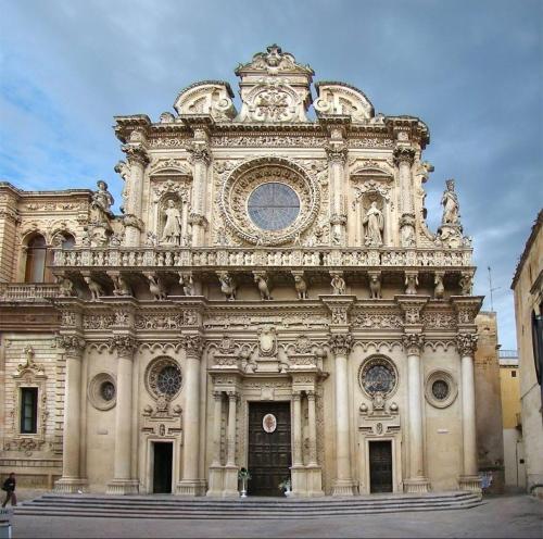 a large building with a clock on top of it at B&B Passione Salento in Surbo