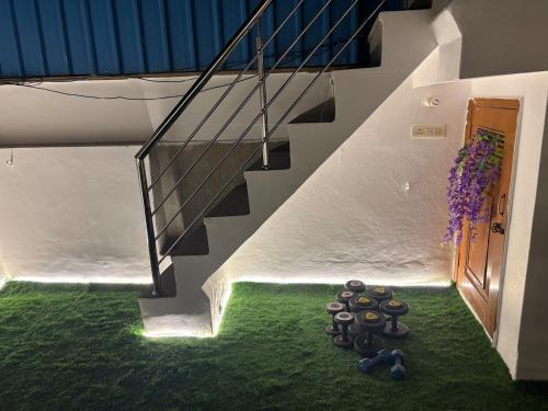a staircase with a bunch of rocks on the grass at The Royal retreat in New Delhi