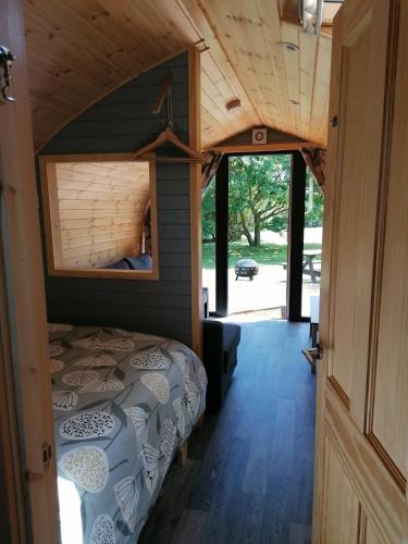 a bedroom with a bed in a tiny house at Cosy Camping Suffolk in Ipswich