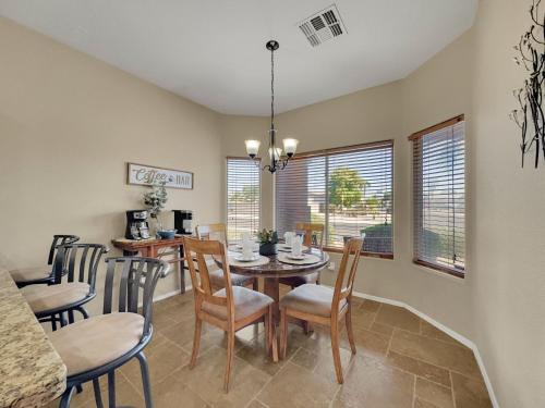 a dining room with a table and chairs at 120th Avondale in Avondale