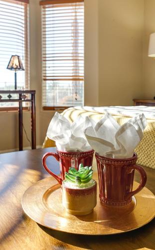 two coffee cups sitting on a table with food at 120th Avondale in Avondale