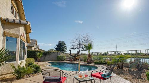 a patio with chairs and a table and a pool at 120th Avondale in Avondale