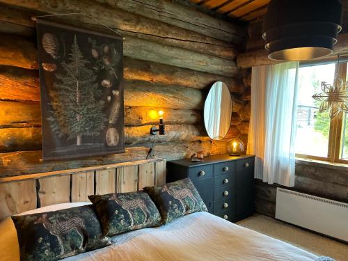 Un dormitorio con una cama en una cabaña de troncos en VillaAngie Ruka, en Ruka