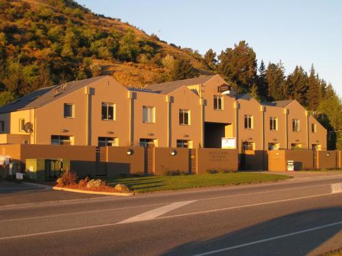 a large building on the side of a road at Queenstown Gateway Apartments in Queenstown